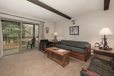 a living room with a couch and a table at Hi Country Haus Unit 1908 in Winter Park