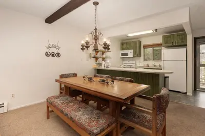 a dining room with a wooden table and chairs at Hi Country Haus Unit 1908 in Winter Park