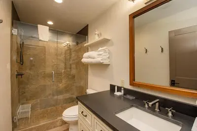 a bathroom with a shower and a sink and a mirror at Hi Country Haus Unit 2121 in Winter Park