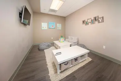 a waiting room with a white table and chairs at Hi Country Haus Unit 2121 in Winter Park