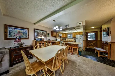 a kitchen and dining room with a table and chairs at Hi Country Haus Unit 2201 in Winter Park