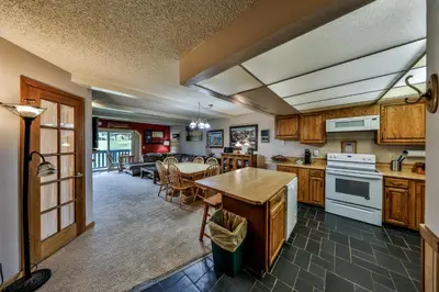 a kitchen with a table and a dining room at Hi Country Haus Unit 2201 in Winter Park