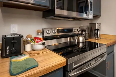 a kitchen with a stove and a microwave at Hi Country Haus Unit 2506 in Winter Park