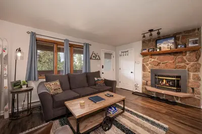 a living room with a couch and a fireplace at Hi Country Haus Unit 2506 in Winter Park