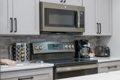 a kitchen with a microwave and a stove top oven at Silverado I Building A Unit 101 in Winter Park