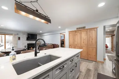 a kitchen with a large sink and a living room at Silverado I Building A Unit 101 in Winter Park