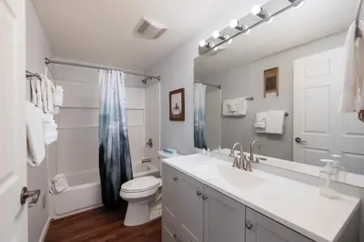a bathroom with a sink and a toilet and a mirror at Waterside West A303 in Fraser