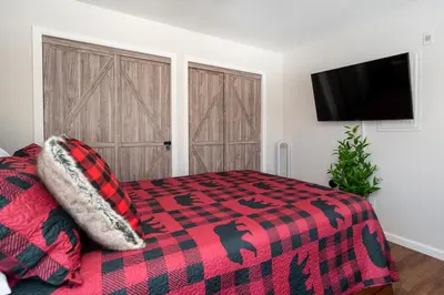 a bedroom with a bed and a tv on a wall at Waterside West A303 in Fraser