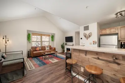 a kitchen with a counter and a living room at Waterside West A303 in Fraser