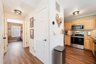 a kitchen with a white door and a stove at Waterside West A303 in Fraser