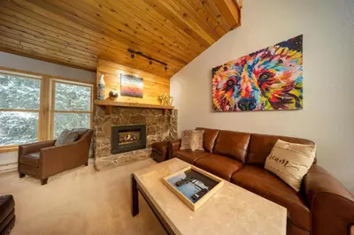 a living room with a couch and a fireplace at Creekside Unit 403 in Winter Park