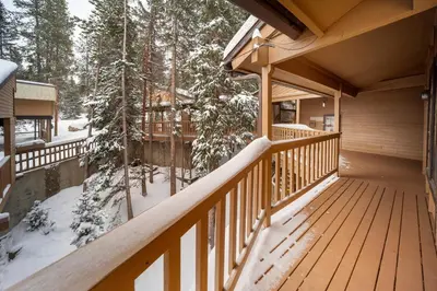 a balcony of a cabin in the woods in the snow at Creekside Unit 403 in Winter Park