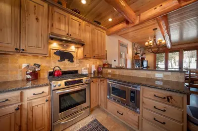 a kitchen with wooden cabinets and a stove top oven at 500 North Lupine in Fraser