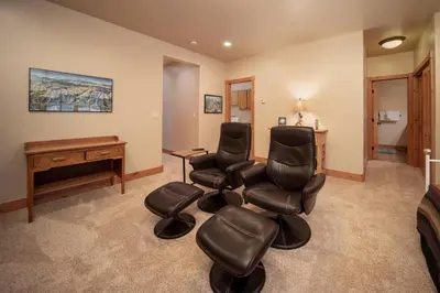 a room with two chairs and a desk and a piano at 500 North Lupine in Fraser