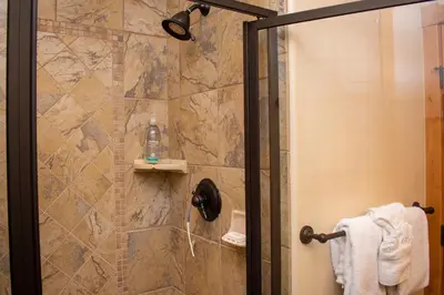 a bathroom with a shower with a glass door at 500 North Lupine in Fraser
