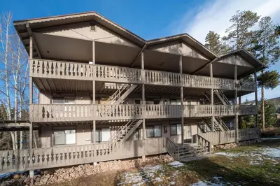a large building with decks and a river at Hi Country Haus Unit 0309 in Winter Park