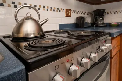 a tea kettle sitting on top of a stove in a kitchen at Hi Country Haus Unit 0309 in Winter Park