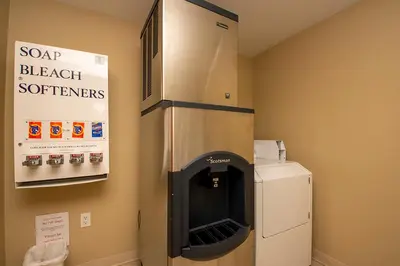 a refrigerator in a room with a sign on the wall at Fraser Crossing 3518 Studio in Winter Park