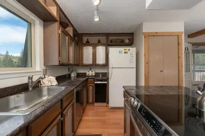 a kitchen with a sink and a white refrigerator at Hi Country Haus Unit 1618 in Winter Park