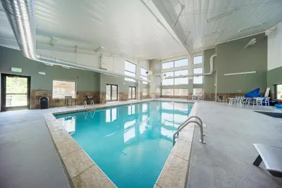 a large swimming pool with blue water in a building at Hi Country Haus Unit 1903 in Winter Park
