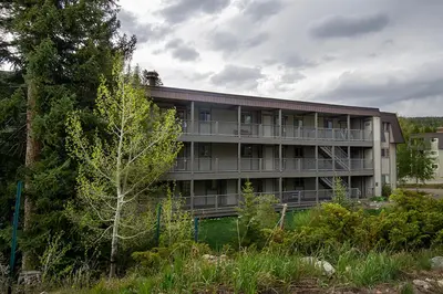 an apartment building with trees in front of it at Hi Country Haus Unit 1903 in Winter Park