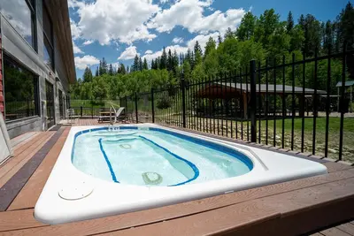 a hot tub on the deck of a house at Hi Country Haus Unit 1903 in Winter Park