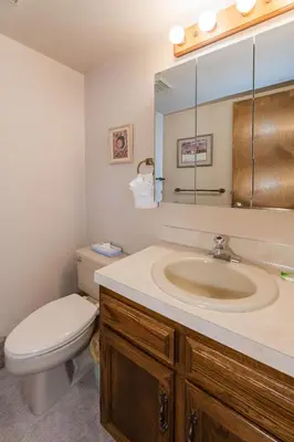 a bathroom with a sink and a toilet and a mirror at Hi Country Haus Unit 2501 in Winter Park