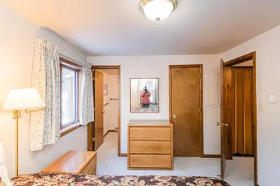 a bedroom with a bed and a desk and a window at Hi Country Haus Unit 2501 in Winter Park