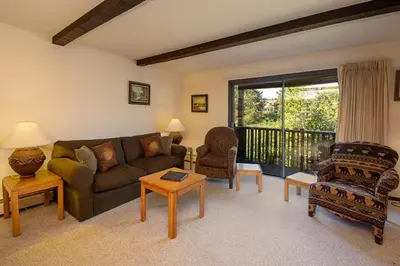 a living room with a couch and chairs and a balcony at Hi Country Haus Unit 2111 in Winter Park