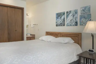 a bedroom with a bed with two pillows on it at Hideaway Village Alpine 4 in Winter Park