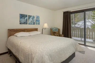 a bedroom with a bed and a large window at Hideaway Village Alpine 4 in Winter Park