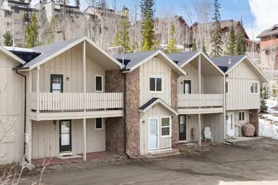 a large house with white at Hideaway Village Alpine 4 in Winter Park