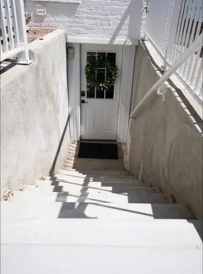 a stairway leading to a white door with a plant at Artsy Platt Park Apartment Guest Suite for 4, QUICK Mountain Access! in Denver