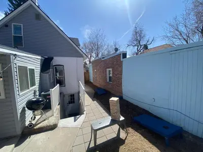 a backyard with a house and a white fence at Artsy Platt Park Apartment Guest Suite for 4, QUICK Mountain Access! in Denver