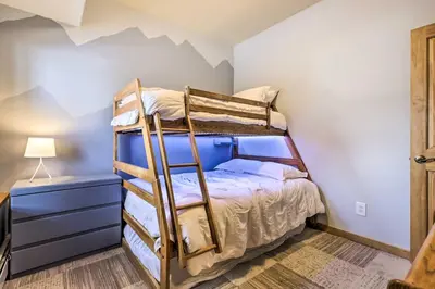 a bedroom with a bunk bed with a ladder at Winter Park Townhome with Hot Tub, Ski Shuttle! in Winter Park