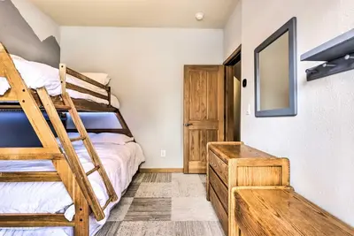 a bedroom with two bunk beds and a mirror at Winter Park Townhome with Hot Tub, Ski Shuttle! in Winter Park