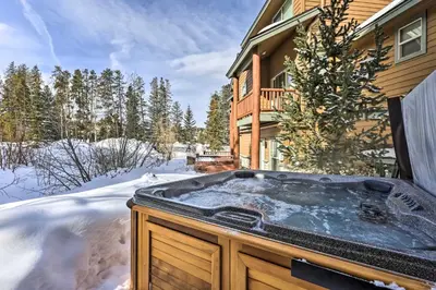 a hot tub in the snow in front of a house at Winter Park Townhome with Hot Tub, Ski Shuttle! in Winter Park
