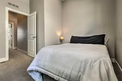 a bedroom with a large white bed with a black pillow at Modern Townhome Rental 1 Mi to Downtown Denver! in Denver