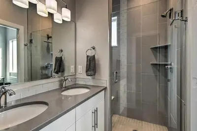 a bathroom with two sinks and a shower at Modern Townhome Rental 1 Mi to Downtown Denver! in Denver