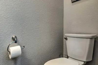 a bathroom with a toilet and a roll of toilet paper at Modern Townhome Rental 1 Mi to Downtown Denver! in Denver