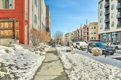 a sidewalk covered in snow next to a street with buildings at Modern Townhome Rental 1 Mi to Downtown Denver! in Denver
