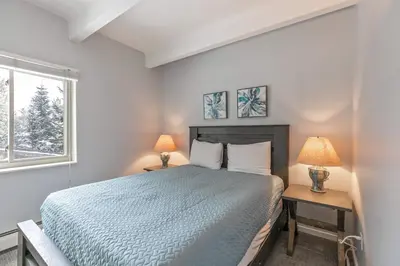 a bedroom with a bed and two lamps and a window at Lake View Condo: Walk To Downtown/Lake Dillon in Dillon