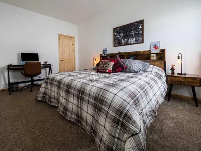 a bedroom with a bed and a desk with a computer at Stillwater, 0020 in Grand Lake