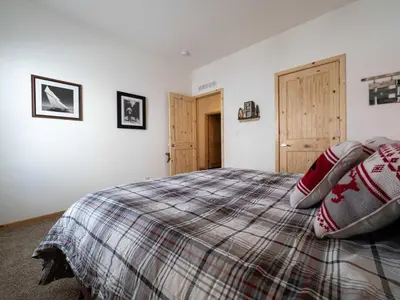 a bedroom with a bed with a plaid blanket at Stillwater, 0020 in Grand Lake
