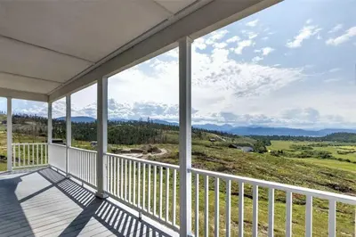 a balcony of a house with a view of the mountains at Stillwater, 0020 in Grand Lake