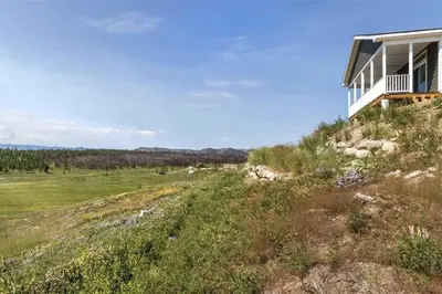 a house on the side of a hill with a field at Stillwater, 0020 in Grand Lake