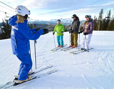 a group of people on skis in the snow at Silver Mill 8200 - 1Br-Walk to Slopes! Kids Ski Free! condo in Keystone