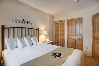 a bedroom with a large white bed with white pillows at Silver Mill 8200 - 1Br-Walk to Slopes! Kids Ski Free! condo in Keystone
