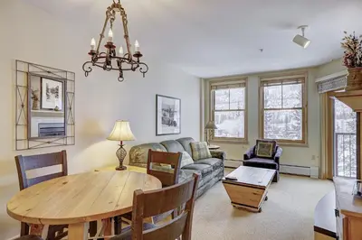 a living room with a table and a couch at Silver Mill 8200 - 1Br-Walk to Slopes! Kids Ski Free! condo in Keystone