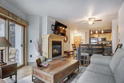 a living room with a couch and a fireplace at Premier Silver Mill 8229 - 2Br-Walk to Slopes! Kids Ski Free! condo in Keystone